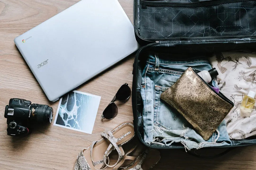 person packing a suitcase with clothes and travel essentials